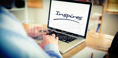 Inspires against businessman working on his laptop
