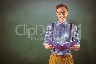 Composite image of geeky student reading a book