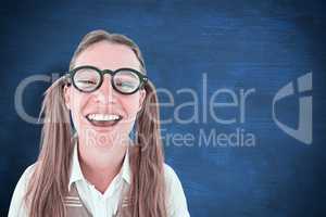 Composite image of female geeky hipster smiling at camera
