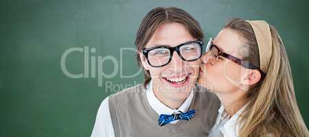 Composite image of geeky hipster kissing her boyfriend