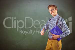 Composite image of geeky student holding a notebook