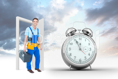 Composite image of happy plumber carrying tool box