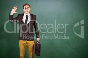 Composite image of young geeky businessman holding briefcase