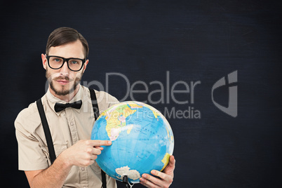 Composite image of geeky hipster holding a globe