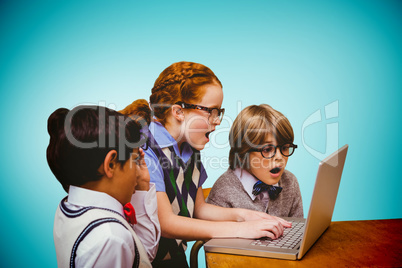 Composite image of pupils using laptop