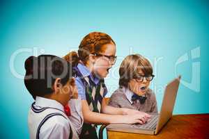 Composite image of pupils using laptop