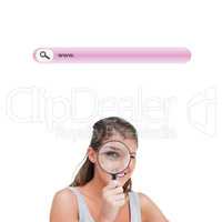 Composite image of woman looking through a magnifying glass