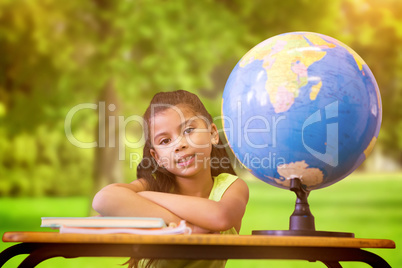 Composite image of cute pupils sitting at desk