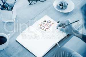 Composite image of man writing notes on diary