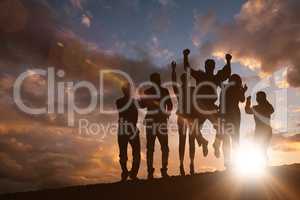 Composite image of silhouetters celebrating