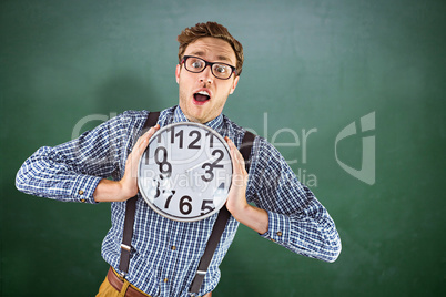 Composite image of geeky businessman holding a clock Composite image of geeky businessman holding a clock