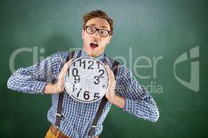 Composite image of geeky businessman holding a clock