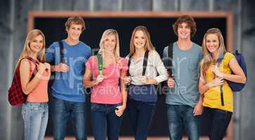 Composite image of smiling group with backpacks on as they smile