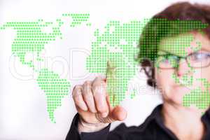 Woman pointing at digital world map