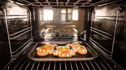 Baking Gingerbread men in the oven. Cooking in the oven.