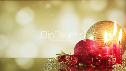 christmas balls and candle on shiny background seamless loop