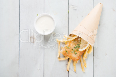 Top view fish and chips wrapped in paper cone