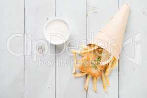 Top view fish and chips wrapped in paper cone