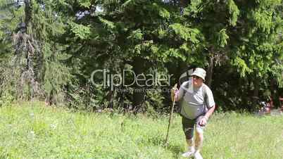 Mature adult man walking with backpack