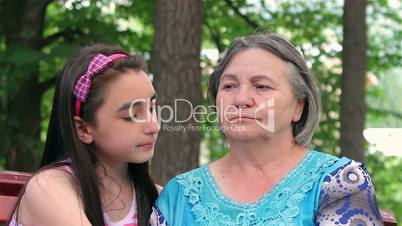 Sad grandmother with her little granddaughter