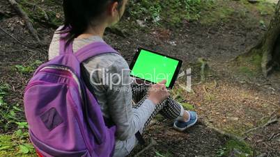 Teenage girl using tablet pc with green screen