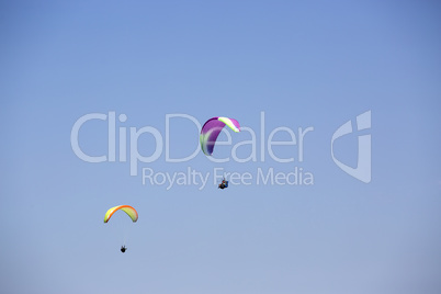 Colorful paragliders with blue sky