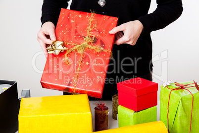 Woman bagging Christmas gifts Woman bagging Christmas gifts