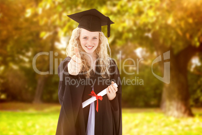 Composite image of teenage girl celebrating graduation with thum