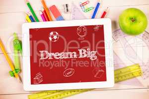 Dream big against students desk with tablet pc