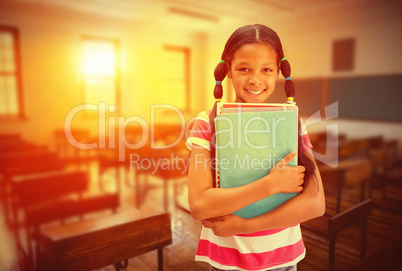 Composite image of cute pupil smiling at camera in library