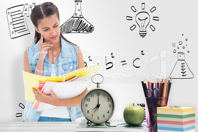 Composite image of student studying from folders