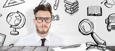 Composite image of geeky young businessman looking at camera