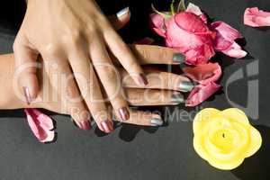 Woman manicure arranged with rose