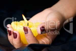 Woman manicure arranged with candle