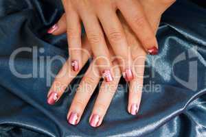 Woman manicure arranged with blue satin