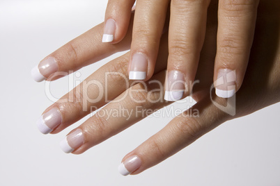 Woman?s hand with French manicure isolated. Nail polish.