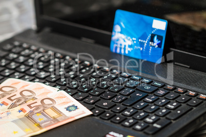 Money and credit card on keyboard