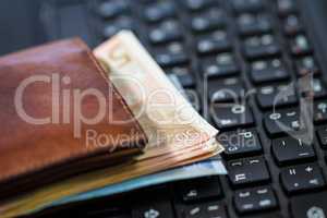 Wallet and  money on keyboard