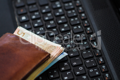 Wallet and  money on keyboard