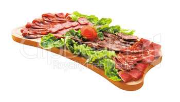 Cold cuts on wood plateau isolated on white. Gourmet food.