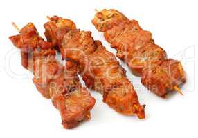 Chicken skewers isolated over white plate.