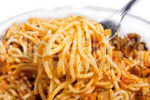Delicious summertime pasta. Pasta with fork in it isolated on white.