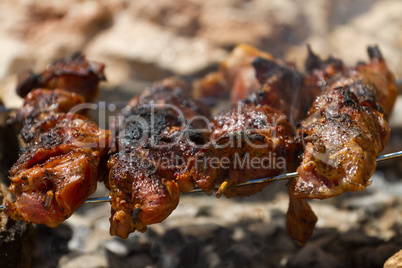 Pork skewers on wooden coals