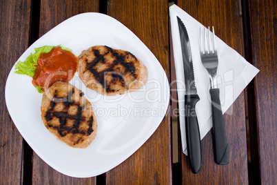 Two meatballs on white plate. Proper for restaurant menu.