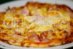 Pizza with tomato and cheese on plate