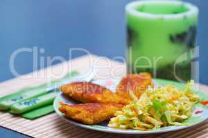 Breaded chicken meat with green salad