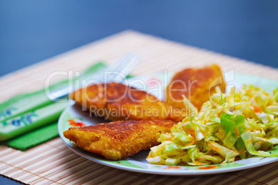 Breaded chicken meat with green salad