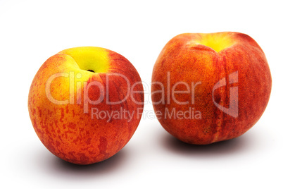 Two tasty juicy peaches on a white background