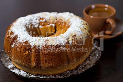 Round cake with sugar top and coffee. Traditional cuisine.