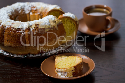 Round cake with sugar top and coffee. Traditional cuisine.